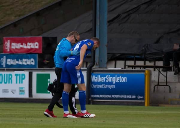 Josh Staunton limps off in Town's 2-0 win over Barrow on August 7.