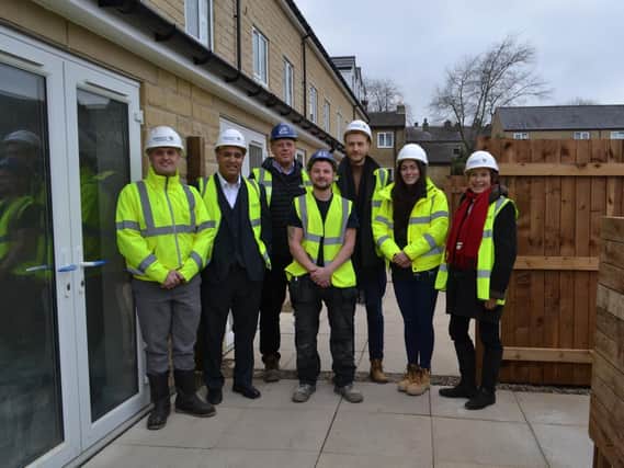 Representatives from Calderdale Council, Connect Housing and West End Joiners and Builders outside the new homes on Hopwood Lane during their development.