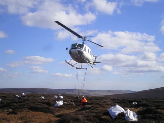 Bags of cut heather airlifted onto the moor to help protect vital peatland (Read-Only)