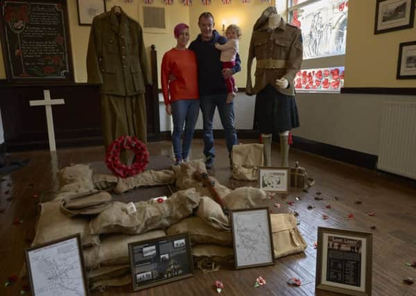 Samantha Oldfield and Craig Farren with their granddaughter Lela Kerr with the WW1 display at The Jubilee, Halifax.