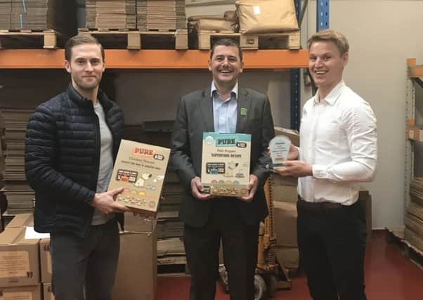 Nick Worsnop, chairman of Business for Calderdale, presents Pure Pet Food founders Mat Cockroft and Dan Eha with the monthly accolade.