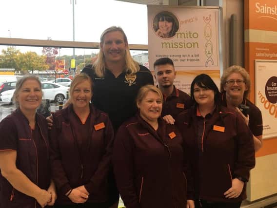 Eorl Crabtree pictured with some of Brighouse Sainsburys staff