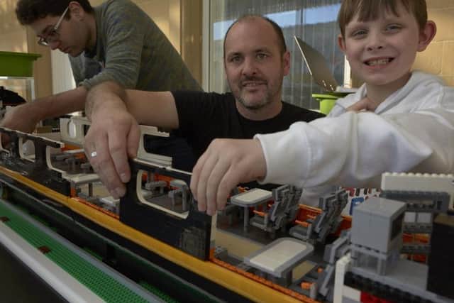 Building the Grand Central train from Lego at Eureka, Halifax. Designer and builder Steve Meyers gets some help from Lego enthusiast Alex Robinson aged eight.