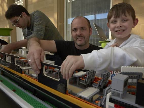 Building the Grand Central train from Lego at Eureka, Halifax. Designer and builder Steve Meyers gets some help from Lego enthusiast Alex Robinson aged eight.