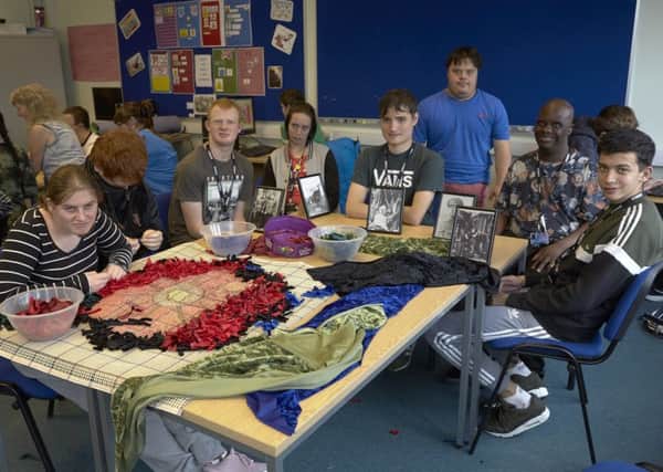 Students at Calderdale College, Halifax making a rag rug for poppy exhibition.