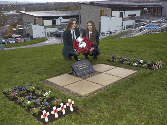 Nieve Whaley and Sophia Woodhouse pose in the new Remembrance Garden at Trinity Academy.