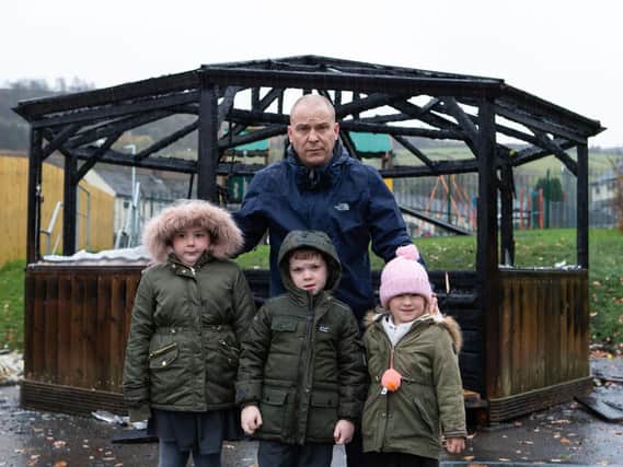 Head teacher Mungo Sheppard with Lyla Milnes, Marshall Bailey and Amy Owen-Smith, upset after an arson attack on the garden shelter at Ash Green Community Primary School, Sunnybank Road, Mixenden