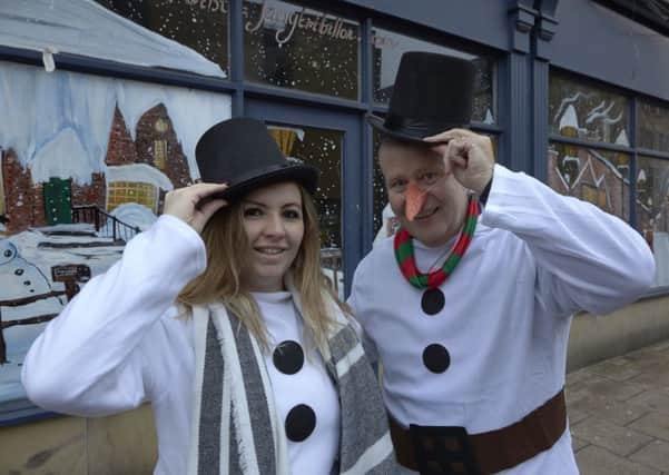 Snowmen Chloe McNeill and David Royton with the Halifax Bid Christmas scene in Northgate, Halifax