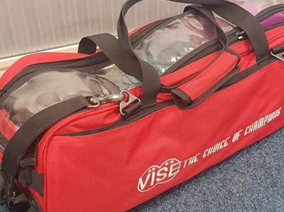 One of the bags containing the bowling balls