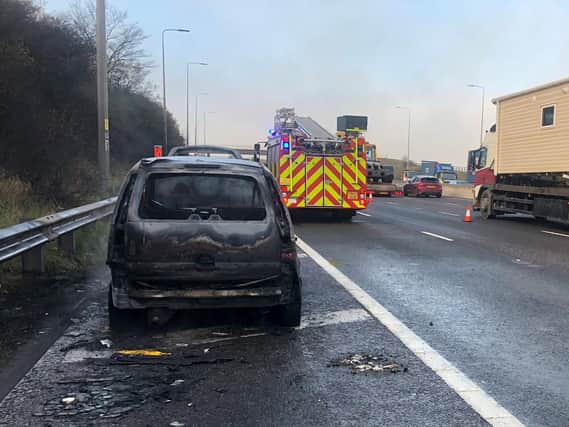 The burnt out car on the M62 where a mum and her baby had to be rescued. (Picture Motorway Bob WYP)