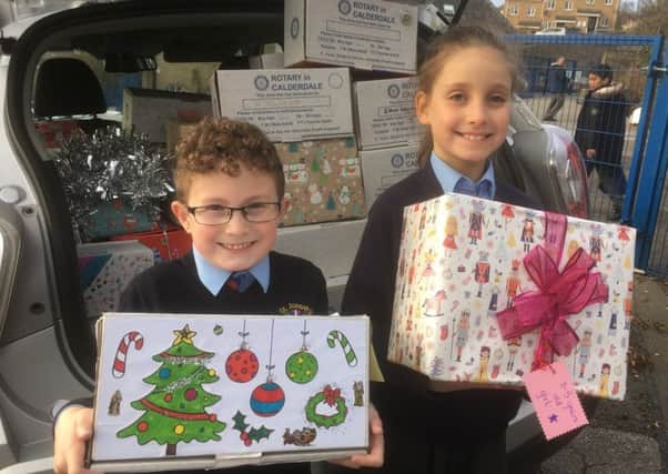 Boxing clever: Pupils at St Josephs Primary School help load a car with 67 shoeboxes.