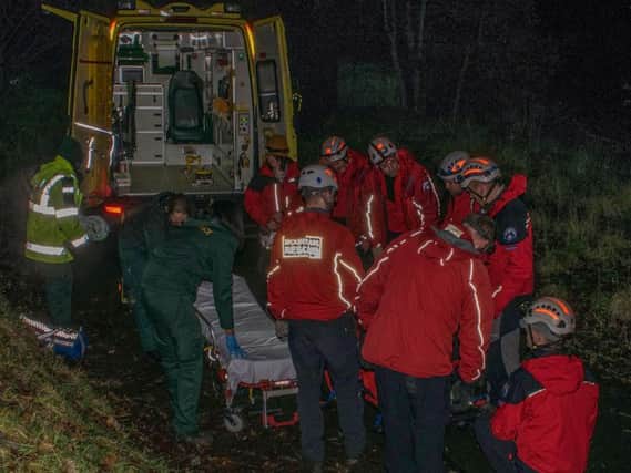 Volunteers were called to assist with the evacuation of a dog walker who had fallen down a steep slope in Todmorden