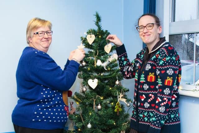 Receptionists Julie Sutcliffe (left) and Lucy Bashforth with the memorial tree
