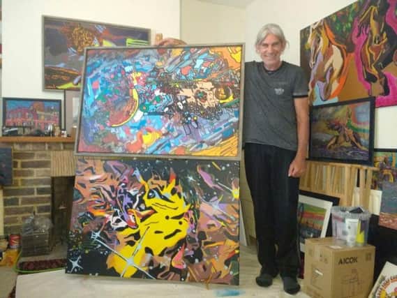 Wayne Sheppard with some of his paintings