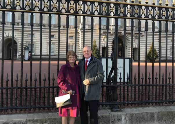 Tim Swift with his wife Megan outside Buckingham Palace