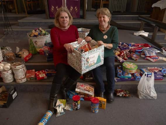 Elsa Fairbanks and Judith Clayton make up Christmas food hampers