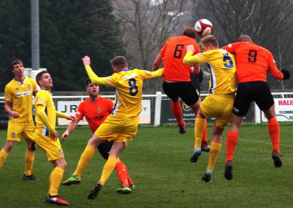 Brighouse Town v Spalding United

pics 2   L to R  capt adam field no 6 town scorer james hurtley  no 9 aaron martin