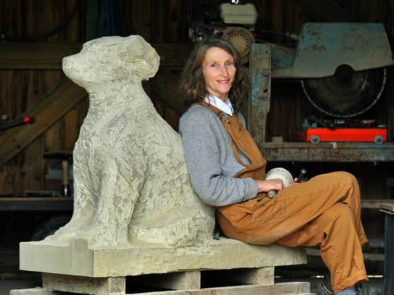 Jennifer Tetlow working on a stone sculpture dog  'Philly'  in  her workshop