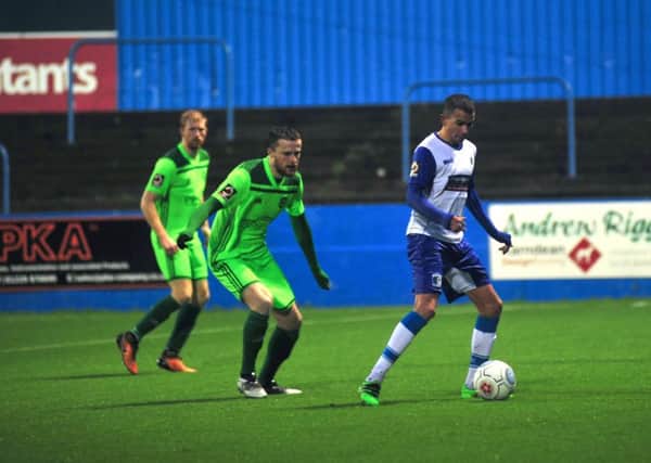 Connor Brown for Barrow AFC and Niall Maher for Halifax in their game last month in the FA Trophy. Photo: NW Mail