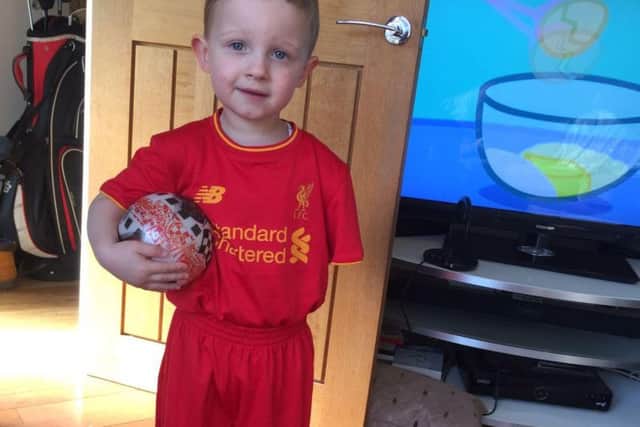 Football-mad Jacob in the strip of his beloved Liverpool FC.
