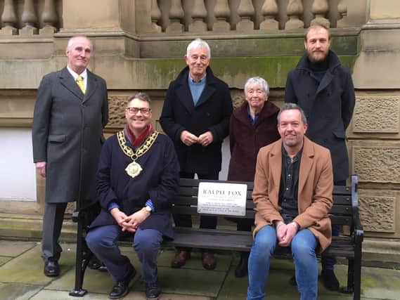 The bench in its new location at Halifax Town Hall  pictured (clockwise from left) Coun Colin Hutchinson, Coun Barry Collins, Coun Anne Collins, Coun Daniel Sutherland, Michael Ainsworth (owner of venue opposite the bench, The Grayston Unity), and the Mayor of Calderdale, Coun Marcus Thompson.