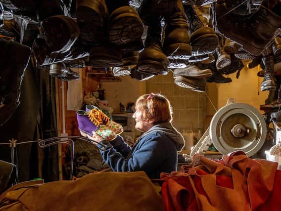 Enduring craft: Sue Greenwood and her husband Alan are keeping the traditional art of Northern clogmaking alive at their business in Mytholmroyd, near Hebden Bridge. Picture: Charlotte Graham