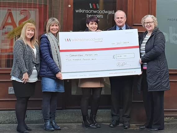 Kath Mashinter (second from left) receives a cheque from staff at Wilkinson Woodward Bearders Solicitors