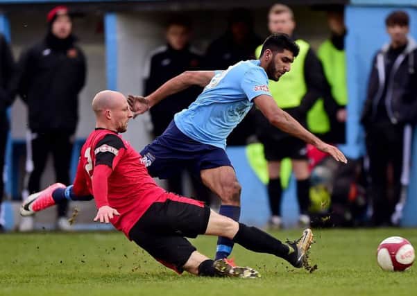 Shiraz Khan (in blue) is a former Halifax Town player now at Ossett United