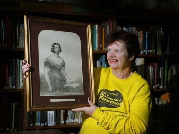 Organiser Ann Talboys with a portrait of singer Susannah Sunderland.