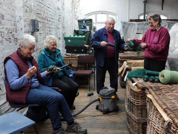 Volunteers at the Calderdale Industrial Museum working behind the scenes preparing bobbings of yarn.