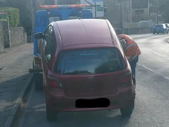The car being seized in Hipperholme (Picture WYP)