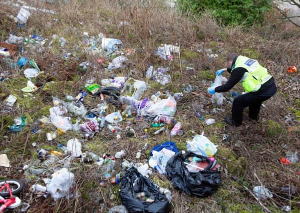 Community Safety Warden at a fly tipping hot spot in Pellon, on tour of Calderdale with anti-social behaviour enforcement officers in Halifax