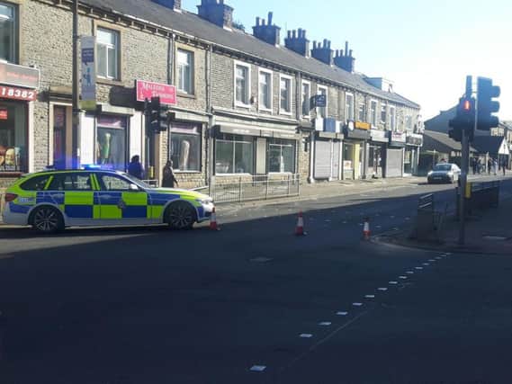 Police officers have closed Queen's Road in Halifax