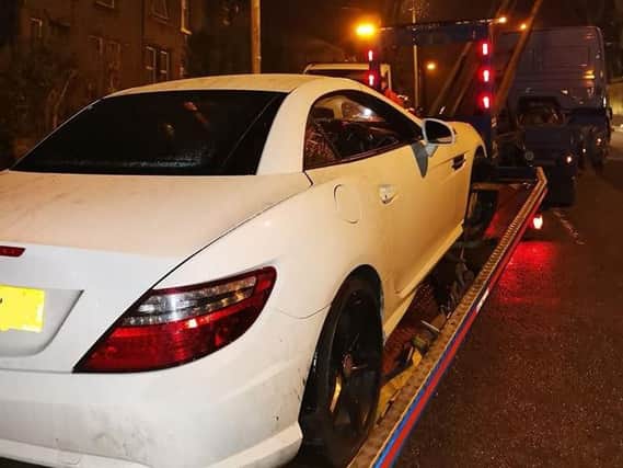The stolen car from Leeds being recovered by police