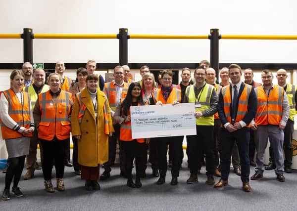 Support: Staff at Elland-based A-SAFE present a cheque for £7,500 to Yorkshire Cancer Research.