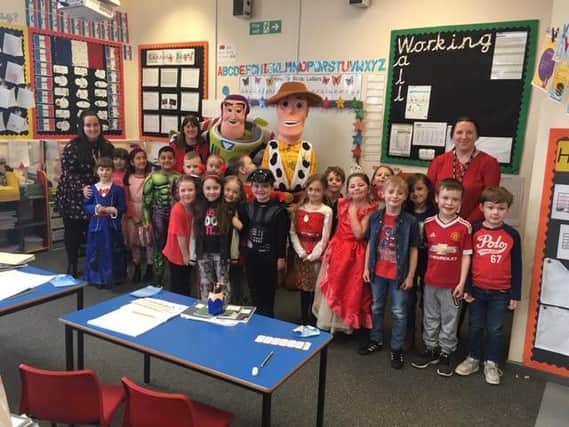 Buzz and Woody with pupils at New Road Primary