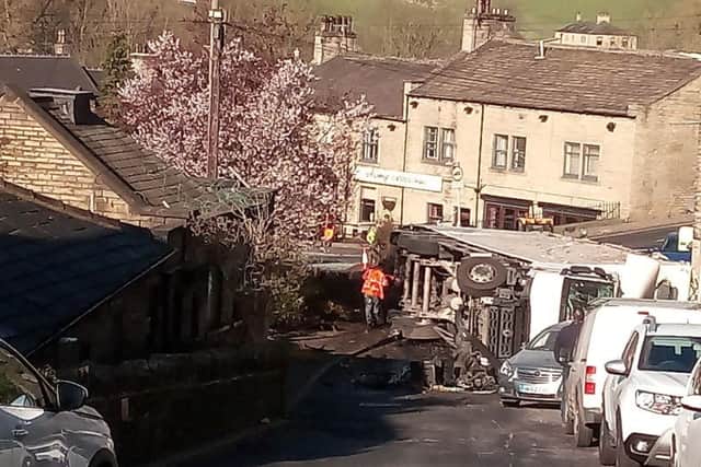 The overturned lorry at the bottom of the steep Hough at Stump Cross, Halifax
