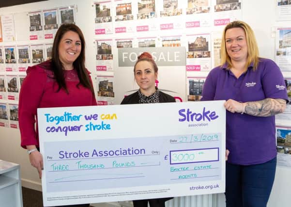 Ami Baxter and Rebecca Thornton, from Baxter Estate Agents, Elland, present a cheque for £3000 to Jo Beverley from the Stroke Association