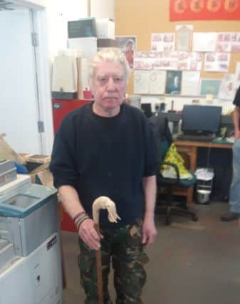 Geoff Hogben, chairman of the Growing Together allotments and member of The Phoenix Shed, at the Threeways Centre in Ovenden, with a walking stick he has made