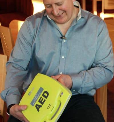 Paul Bailey with the defibrillator that saved his life. Photo: Resuscitation Council (UK).