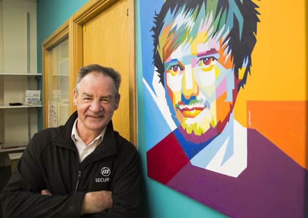 Calderdale Royal Hospital security guard Andy Hardie with his painting of Ed SHeeran in the MacMillan Unit.