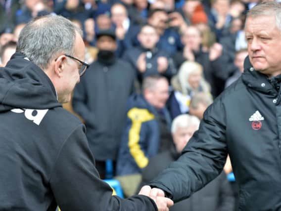 Chris Wilder (right) has pipped Leeds boss Marcelo Bielsa (left) to automatic promotion to the Premier League