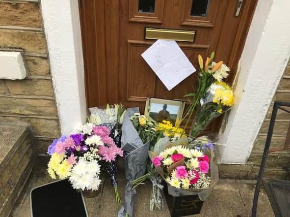 Tributes left outside the home of missing Halifax man Martin Rhodes. Photo: Mark Metcalf