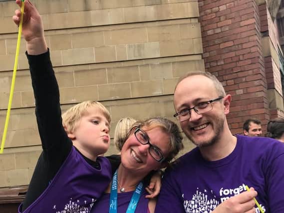 Gabriella Walker with her son Calvin and husband Carl after running the Great Manchester Run.