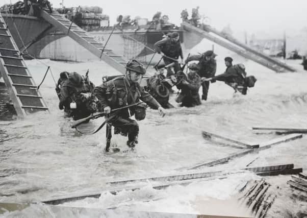 Operation Overlord (The Normandy Landings): D-Day 6 June 1944, The British 2nd Army: Royal Marine Commandos of Headquarters, 4th Special Service Brigade, making their way from LCI(S)s (Landing Craft Infantry Small) onto 'Nan Red' Beach, JUNO Area, at St Aubin-sur-Mer at about 9 am on, 6 June 1944. (Photo by Lt. Handford/ IWM via Getty Images)