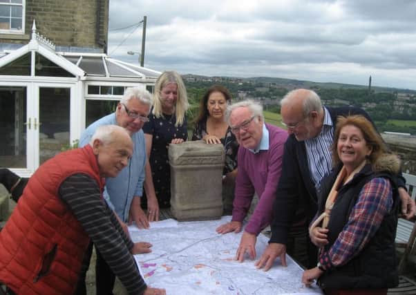 Members of the Neighbourhood Plan Committee discussing the altar and proposed stone replica