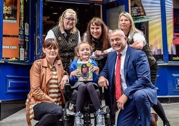 Powering forward: Ivy Wright, 10, with her mum Dayle (left) and Cashino Halifax staff.