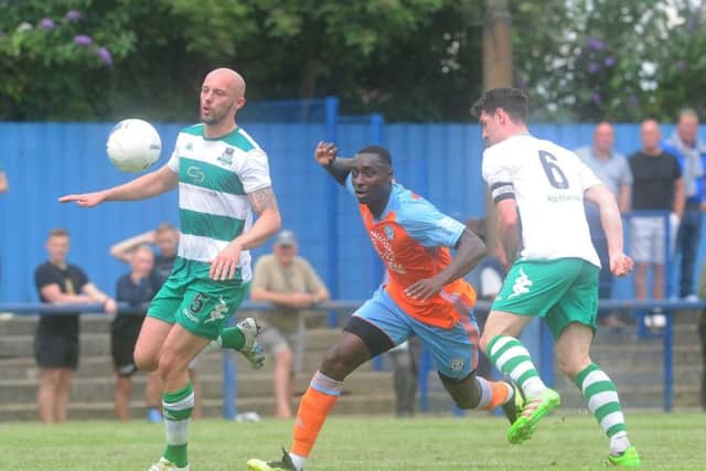 Farsley Celtic v Halifax Town.. Halifax player Toby Sho-Silva is challenged by Jack Higgins.13th July 2019.Picture by Simon Hulme