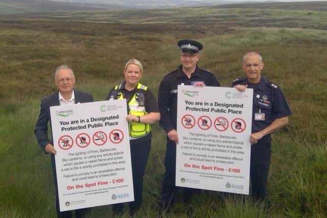 Cllr Tim Swift (Calderdale Councils Leader), Natasha Lymm (the Councils Senior Community Safety Warden), Inspector Ben Doughty from West Yorkshire Police and Geoff Shaw, Watch Commander at West Yorkshire Fire and Rescue Service, with the new Public Space Protection Order signs on moorland in Mytholmroyd.