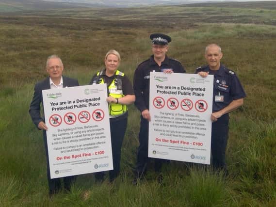Cllr Tim Swift (Calderdale Councils Leader), Natasha Lymm (the Councils Senior Community Safety Warden), Inspector Ben Doughty from West Yorkshire Police and Geoff Shaw, Watch Commander at West Yorkshire Fire and Rescue Service, with the new Public Space Protection Order signs on moorland in Mytholmroyd.